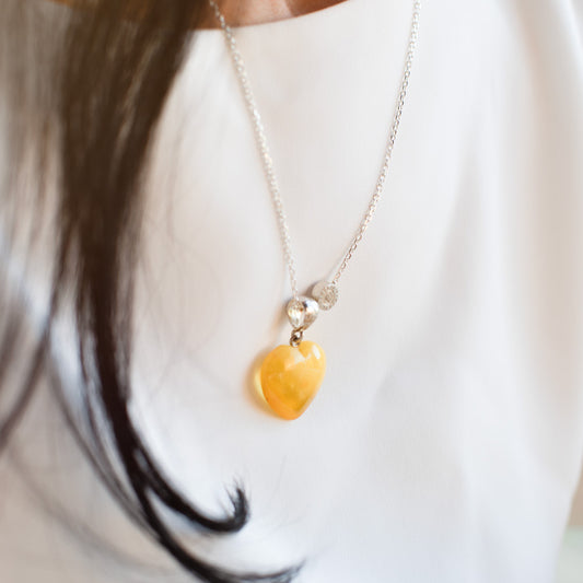 Silver necklace with a heart-shaped amber pendant